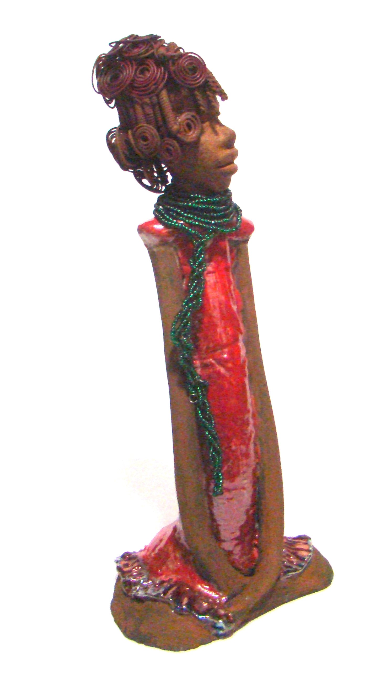 Linda stands 18" x 8" x 5" and weighs 5.1lbs. She has a lovely honey brown complexion. Her hair is rust brown. It took over 3 hours and 40 feet of coiled and spiral 16 gauge wire to complete. Linda' coiled bangs slightly covers her alluring eyes. She has  apple red dress with bright copper ruffled trim. A long  string of emerald green colored beads  cascade well below her neck.