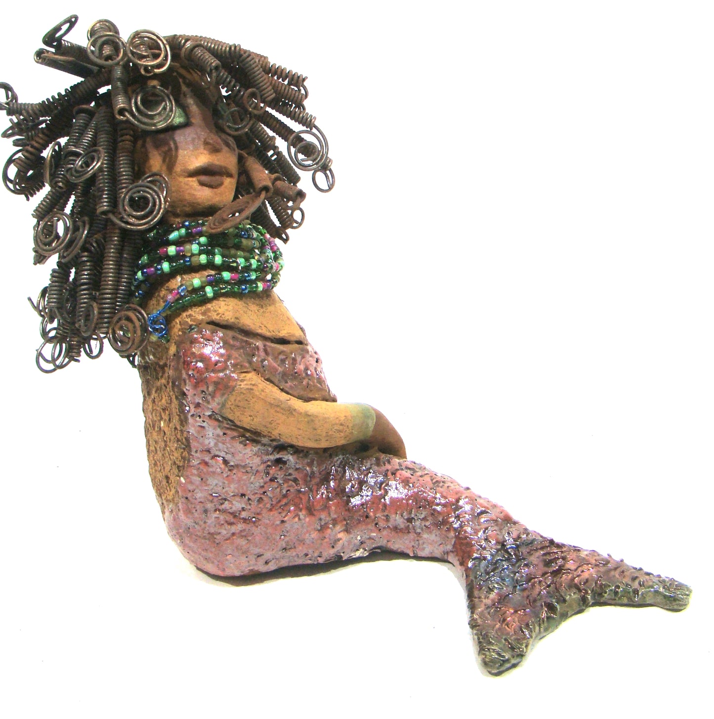 Meranda sits 9" x 10" x 4" and weighs 3.5 lbs. She has over40 feet of 16 gauge wire hair. Meranda complexion is two tone cocoa brown. Her scales are a textured metallic alligator green and copper.