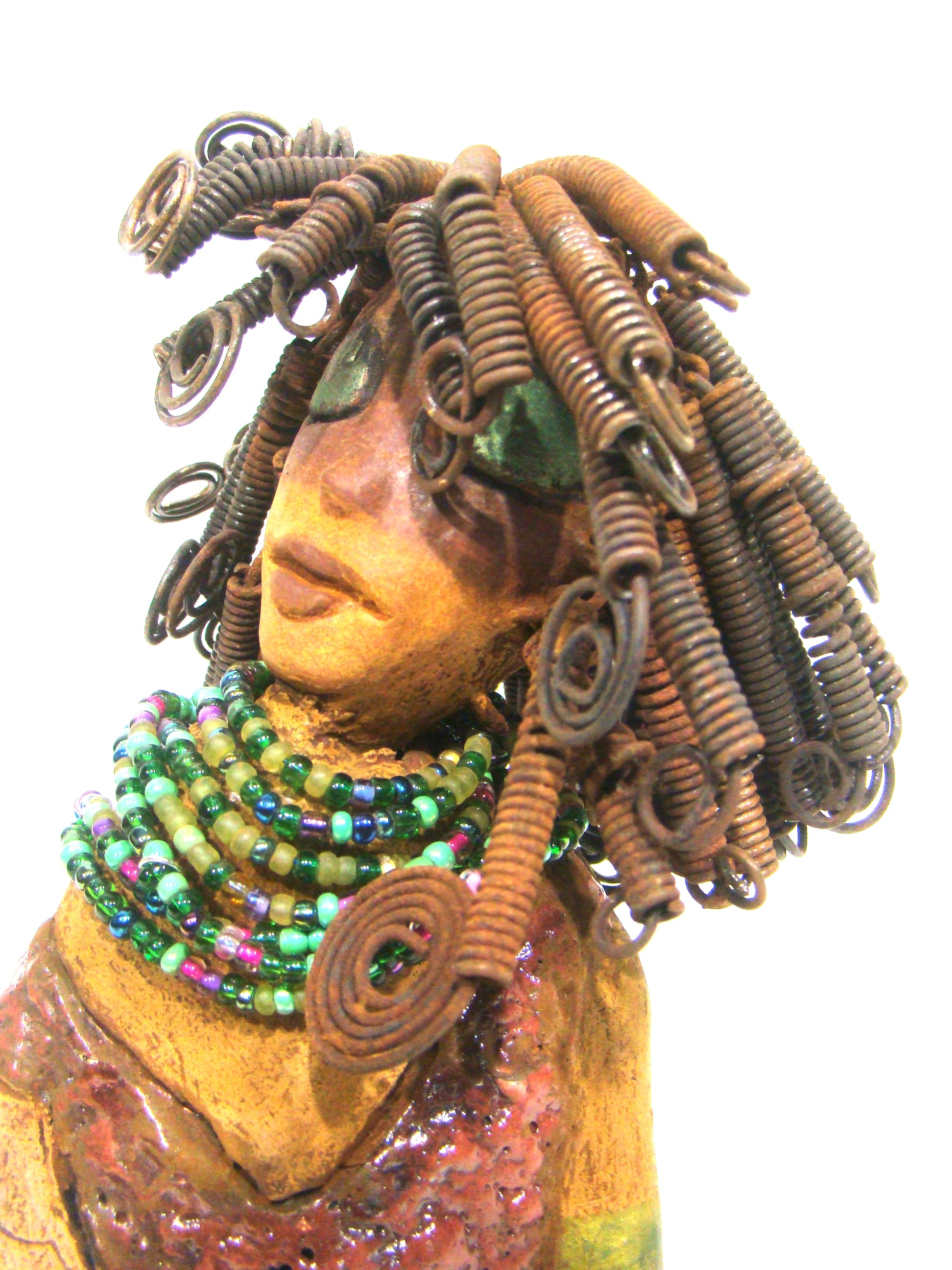 Meranda sits 9" x 10" x 4" and weighs 3.5 lbs. She has over40 feet of 16 gauge wire hair. Meranda complexion is two tone cocoa brown. Her scales  are a  textured metallic alligator green and copper.