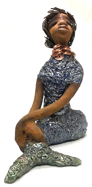 Shelia stands 12" x 10" x 4" and weighs 3.13 lbs.     Shelia has a two tone honey brown complexion.     She has over 15 feet of spiral wire hair which took over two hours to style.     Shelia wears a textured sky blue swimsuit     Her layered spiral copper necklace hangs above her long loving arm.     Shelia is such a ladylike Mermaid. She sits tall and proud. Compare her to Harmony the mermaid.     Give Shelia or Harmony a special place to sit in your home!