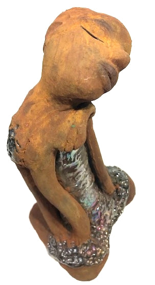 Meet Peace! Peace stands 9" x 5" x 4"and weighs 2.01 lbs. She has a lovely honey brown complexion and bald. Peace has her tilted and resting on her shoulder. Her long loving arms are nested underneath her chin. Peace has a glossy textured metallic dress. Peace is at peace and all is well. Let Peace bring tranquility to your home!