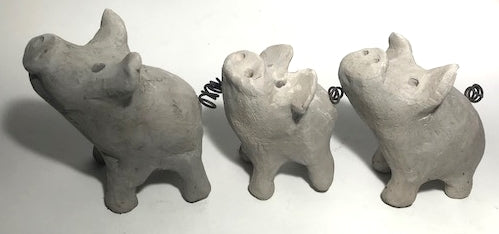 Three smokey grey raku pigs.