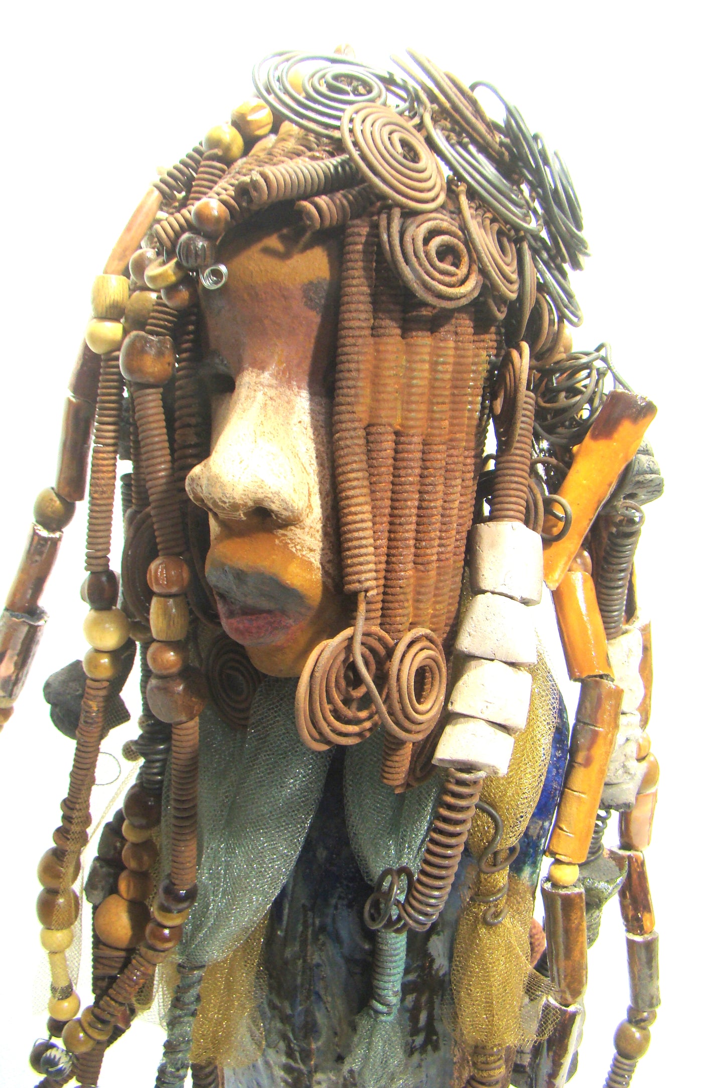 Sabrina stands 23" x 8" x 5" and weighs 9.2 lbs. She as an awesome two tone honey brown complexion. Sabrina's dress is a dark metallic blue with streaks of copper. A blue and gold tulle drapes around her neck Sabrina has long loving arms found typically on Herdew's sculptures. Sabrina sits with anticipation of being a show piece in your home especially now with her New Makeover!