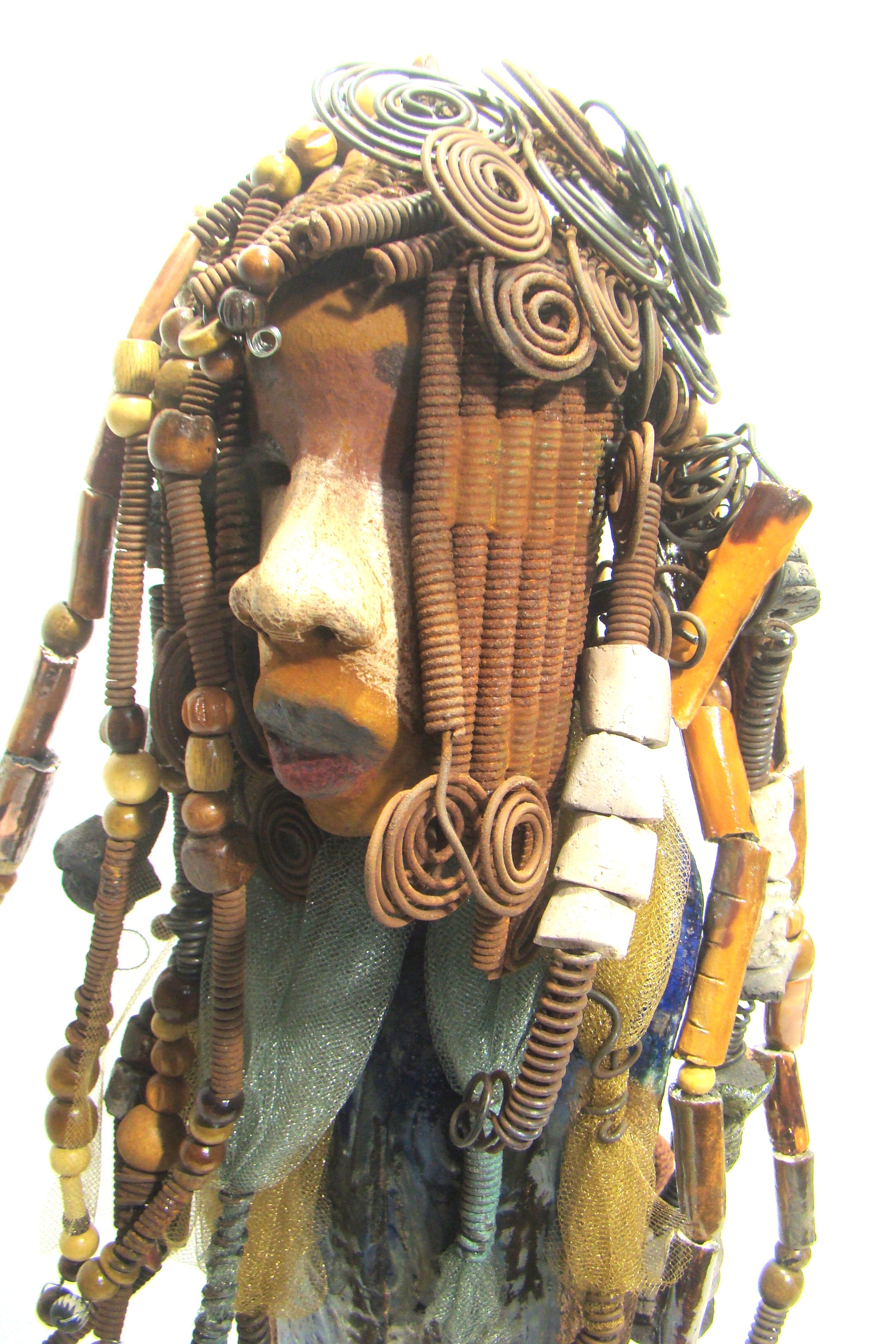 Sabrina stands 23" x 8" x 5" and weighs 9.2 lbs. She as an awesome two tone honey brown complexion. Sabrina's dress is a dark metallic blue with streaks of copper. A blue and gold tulle drapes around her neck Sabrina has long loving arms found typically on Herdew's sculptures. Sabrina sits with anticipation of being a show piece in your home especially now with her New Makeover!