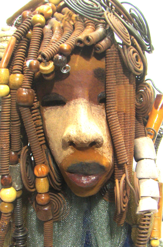 Sabrina stands 23" x 8" x 5" and weighs 9.2 lbs. She as an awesome two tone honey brown complexion. Sabrina's dress is a dark metallic blue with streaks of copper. A blue and gold tulle drapes around her neck Sabrina has long loving arms found typically on Herdew's sculptures. Sabrina sits with anticipation of being a show piece in your home especially now with her New Makeover!
