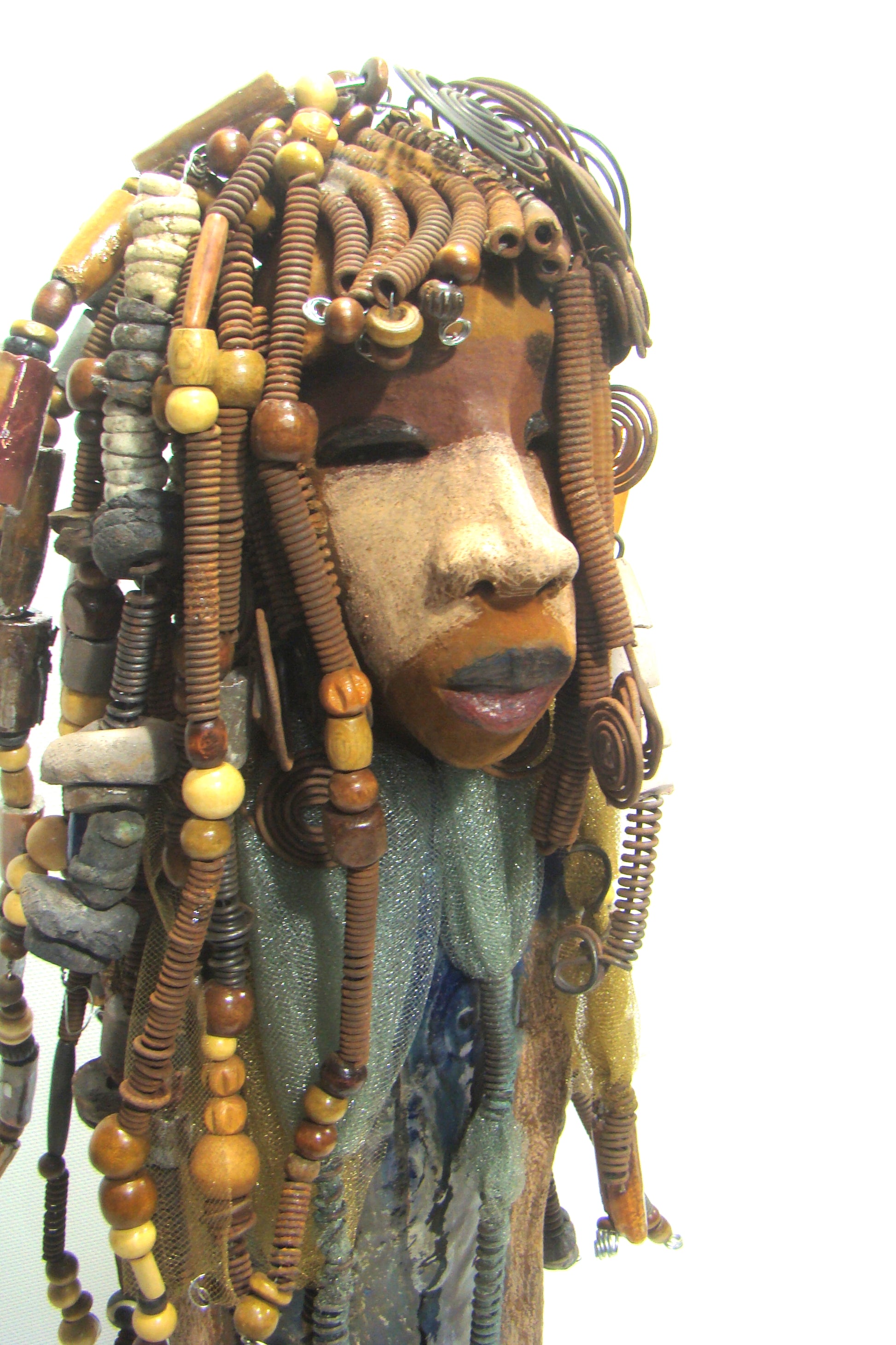 Sabrina stands 23" x 8" x 5" and weighs 9.2 lbs. She as an awesome two tone honey brown complexion. Sabrina's dress is a dark metallic blue with streaks of copper. A blue and gold tulle drapes around her neck Sabrina has long loving arms found typically on Herdew's sculptures. Sabrina sits with anticipation of being a show piece in your home especially now with her New Makeover!