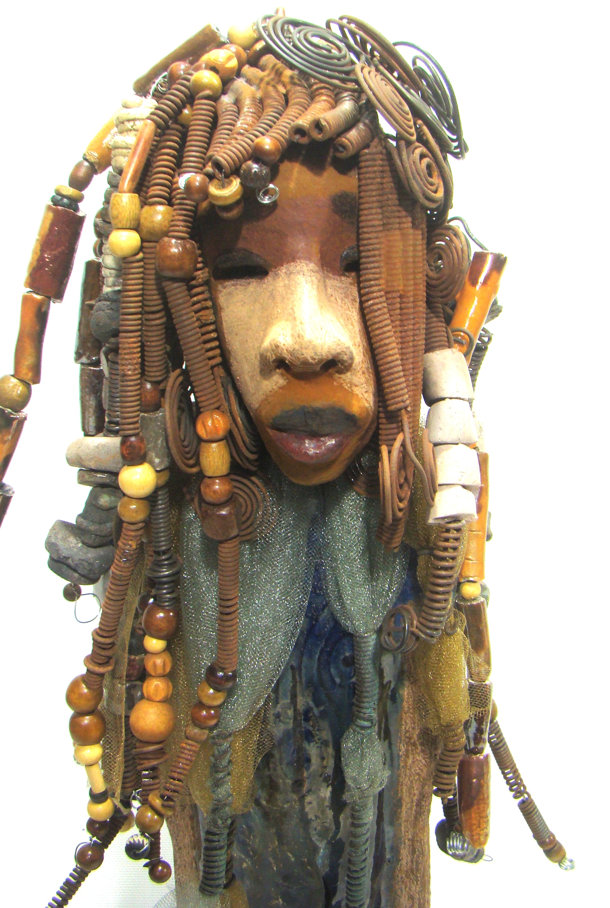 Sabrina stands 23" x 8" x 5" and weighs 9.2 lbs. She as an awesome two tone honey brown complexion. Sabrina's dress is a dark metallic blue with streaks of copper. A blue and gold tulle drapes around her neck Sabrina has long loving arms found typically on Herdew's sculptures. Sabrina sits with anticipation of being a show piece in your home especially now with her New Makeover!