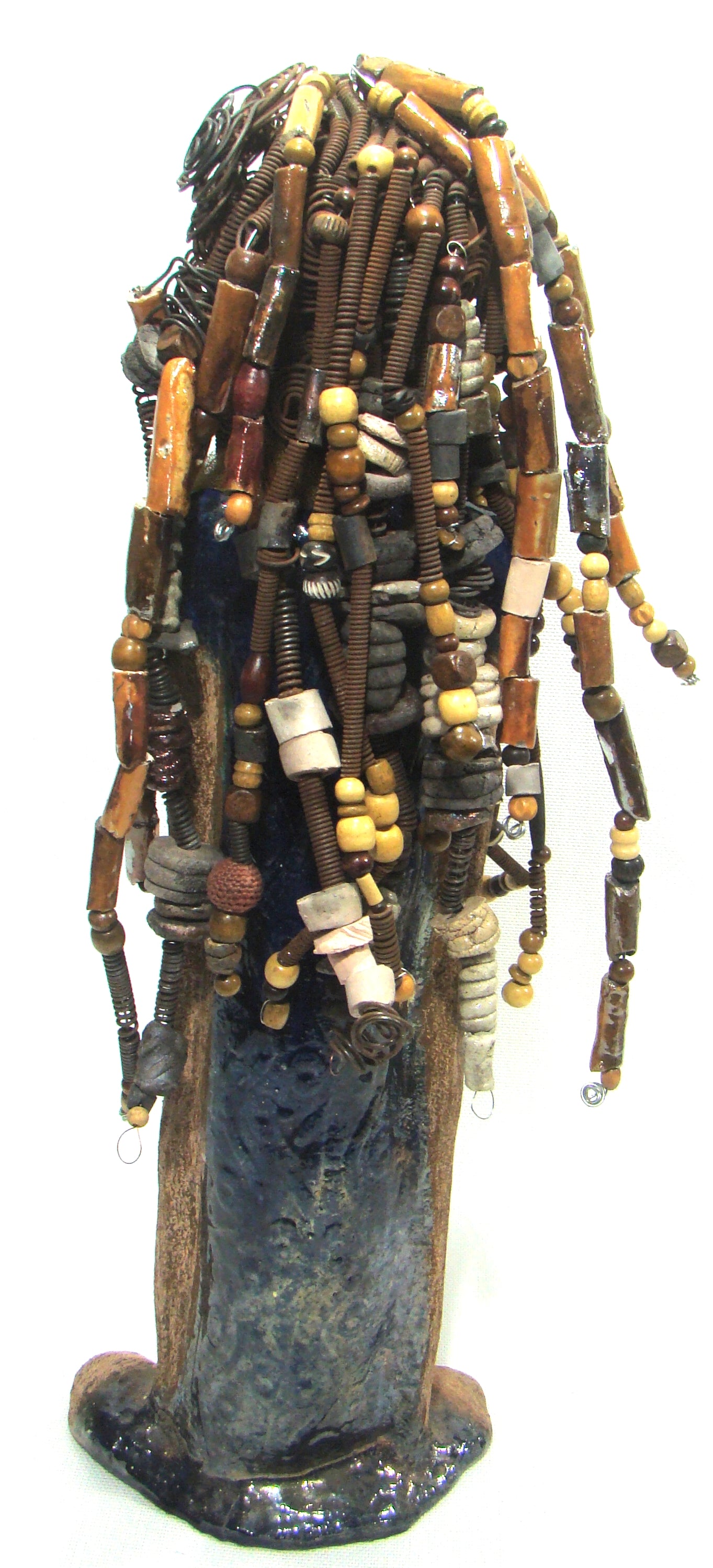 Sabrina stands 23" x 8" x 5" and weighs 9.2 lbs. She as an awesome two tone honey brown complexion. Sabrina's dress is a dark metallic blue with streaks of copper. A blue and gold tulle drapes around her neck Sabrina has long loving arms found typically on Herdew's sculptures. Sabrina sits with anticipation of being a show piece in your home especially now with her New Makeover!