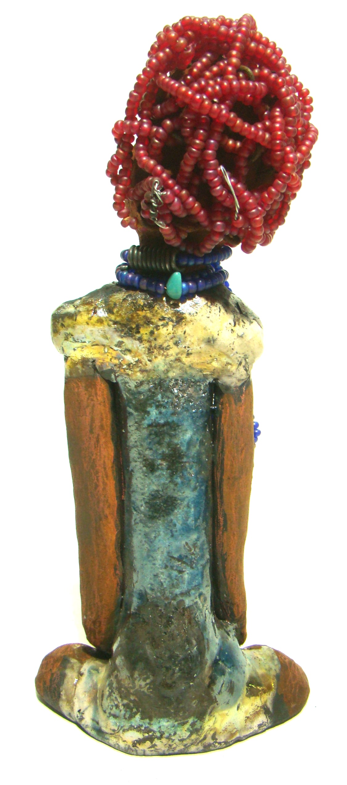 Tiffany stands 10" x 4.5" x 2" and weighs 1.05 lbs. She has a lovely honey tan complexion with purple beaded hair. Tiffany dress is glazed with blue and gold crackle. She wears a blue beaded necklace scarf.