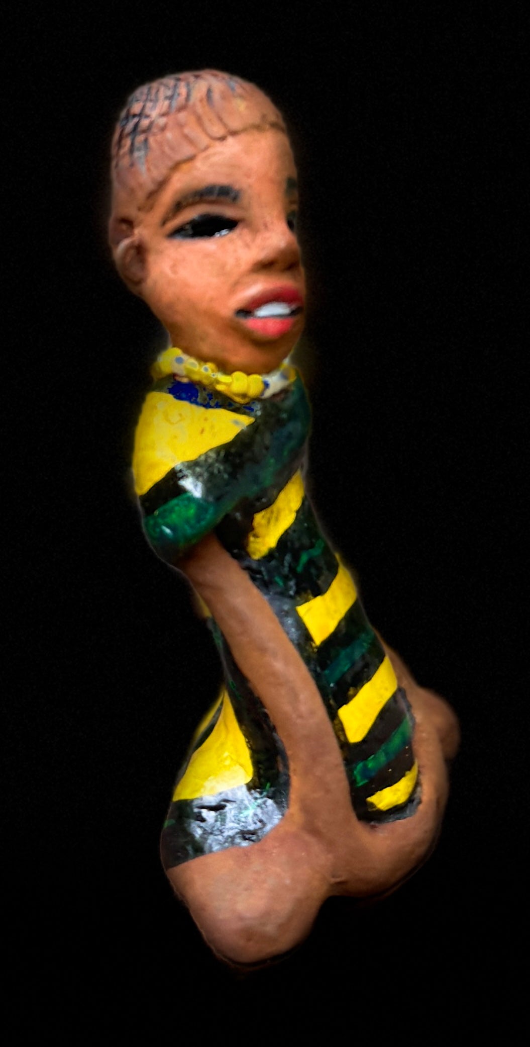 Experience the bold and fearless Kia from the Herdew Collection! This raku fired sculpture stands tall at 6" x 4" x 3" and weighs a brave 9.4 ozs. Clothed in a striking yellow and green dress, Kia's coiled wire hair stretches over 1 foot. With confident outstretched arms, she strikes a yoga pose. Begin your collection with the captivating Kitty and embrace adventure!