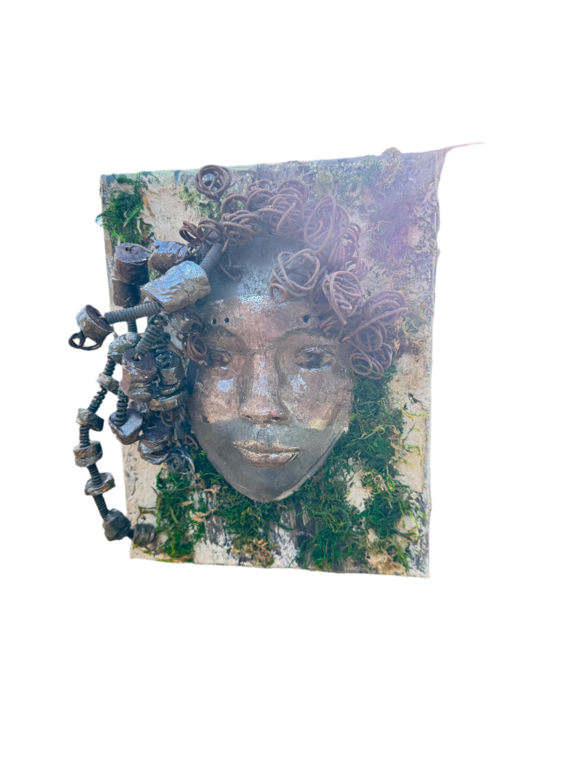 Kai is an 8 x 10 canvas mounted mixed media mask. It weighs approximately 3 pounds and features over 20 feet of 16 gauge wire and 20 handmade Raku fired beads. Her two tone complexion is highlighted by the lush tree bark emulated on the canvas.