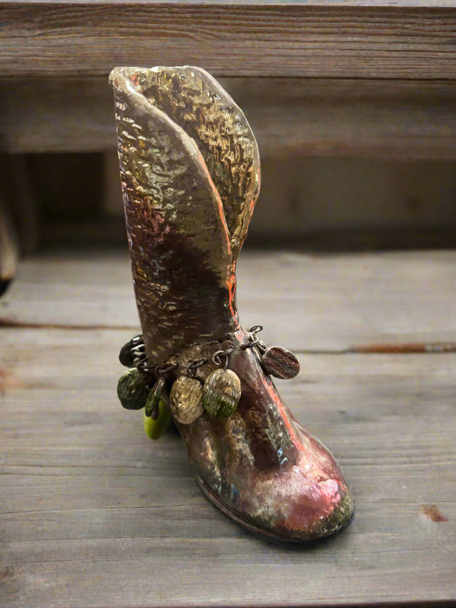 This unique Raku boot serves a dual purpose as both a functional planter and a fashionable statement piece. Combining the traditional Japanese glazing technique with a glossy finish, it measures 7.5" x 5.5" x 2" and has a weight of 1.7 pounds.