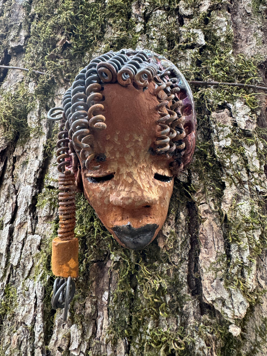 Tricia boasts a beautiful two tone honey-brown complexion, standing 3" x 5" and embellished with coils of wire and hand-made beads. Her hair is graced with hanging twists and was photographed outside amongst the trees. But of course, she will look fantastic no matter where you decide to place her.