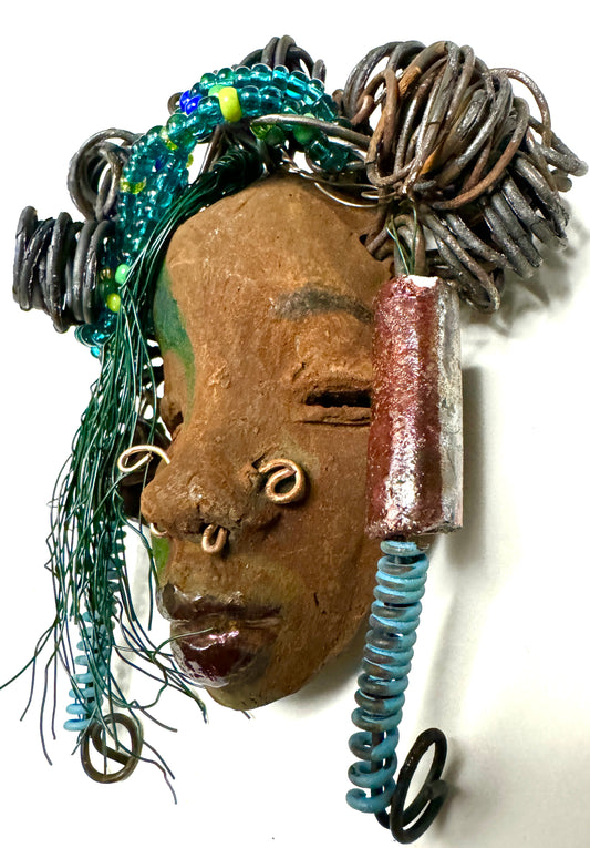 At 5" x 8" in size,  Marcel makes a stunning addition to walls, trees, and shadow boxes. His signature brown and amber braided hair is ornamented with handcrafted Raku beads, while his skin has a warm honey brown hue. Each piece is equipped with over 10 16 & 24-gauge wire in the hair. This fashionable sculpture will bring a modern flair to any room - simply place it in a shadow box and enjoy!
