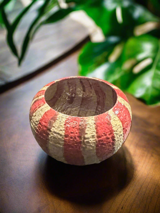 This textured red copper beige strip vase adds a unique touch to any space. With a 4.5 inch height and 6 inch width and depth, this 1 pound and 6 ounce vase is the perfect size for displaying flowers or other decorative items. The glazed interior adds to its natural charm.