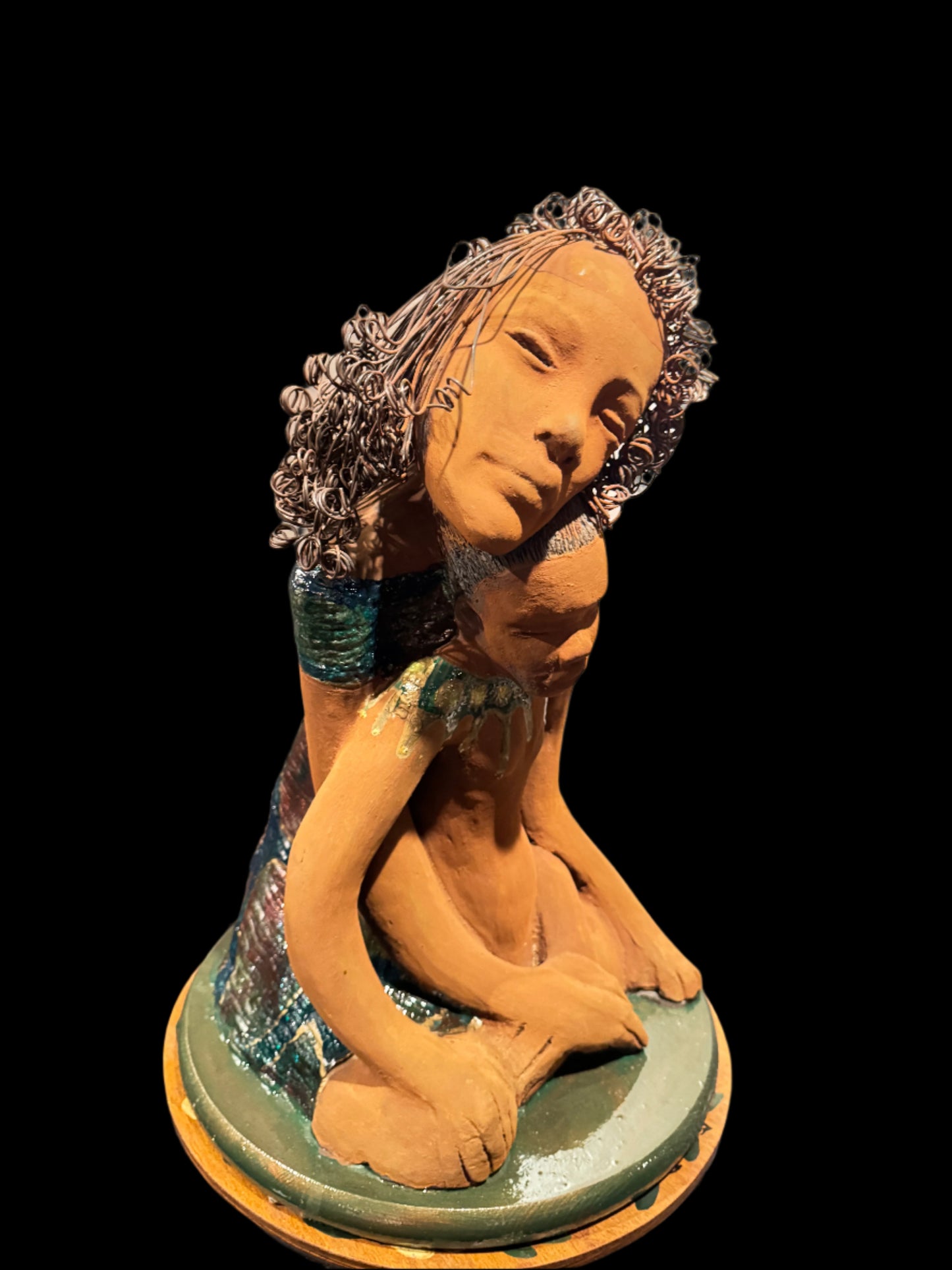 “A mother ‘s love is the first place we ever feel safe, silent, study, and strong”

This heartfelt ceramic sculpture by Lester Jones captures the quiet strength of a mother child bond. With her head gently resting against the child’s, the mother exudes calm and protection while the child leans into her embrace with trust and ease. This piece is approximately 20 inches height and 18 inches in width and depth.

Rendered in a warm earthy tone with coiled wire detailing the hair, the peace, radiates tenderness,