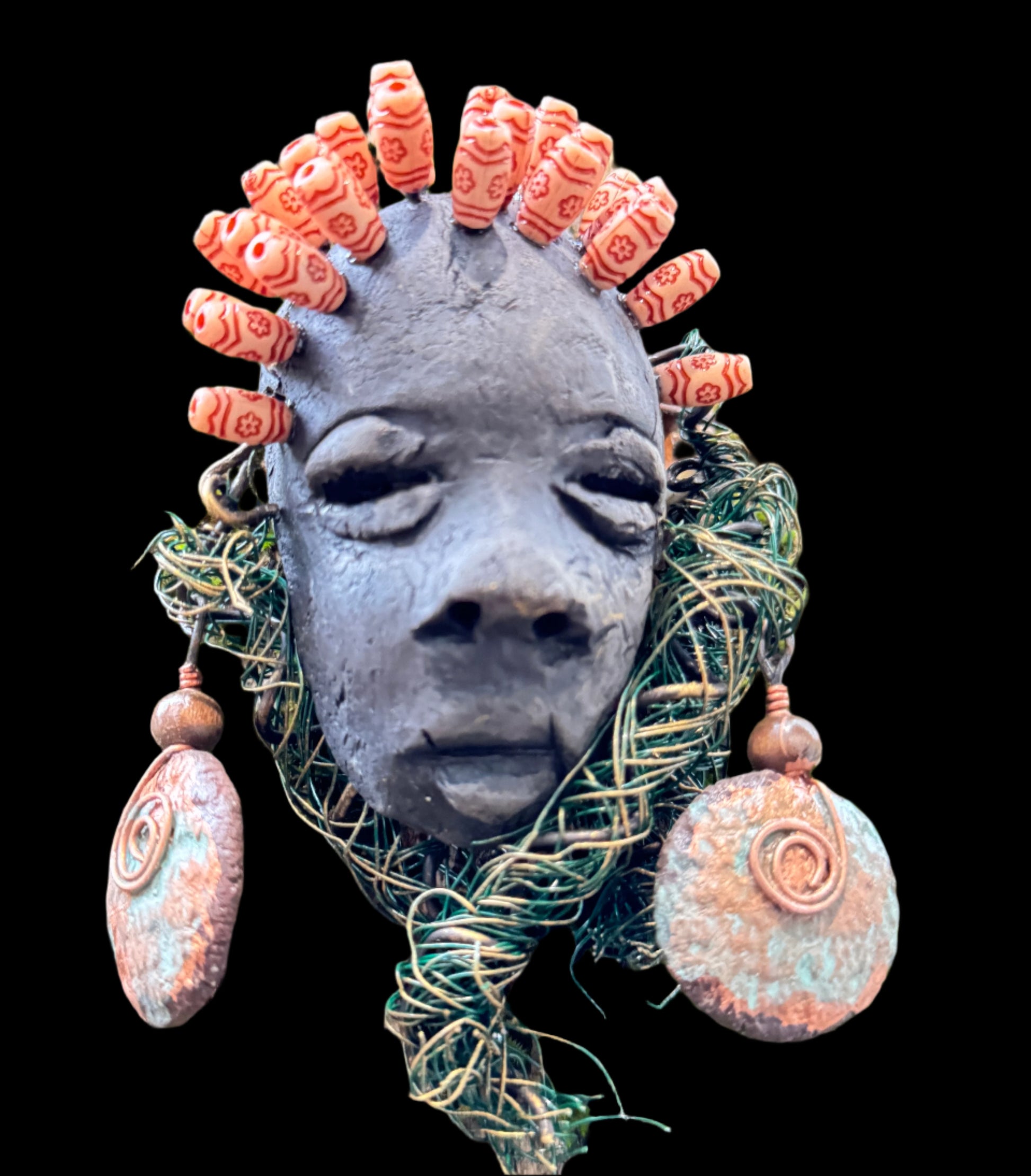 Catto is a 4” x 6” 6oz. mixed media raku fire mask made with 25 feet of 24 and 16 gauge wire. It has a stunning Smokey black complexion and comes with a large Raku fired earring and a wooden bead headdress. This makes Catto a lovely addition to your HerDew mask collection.