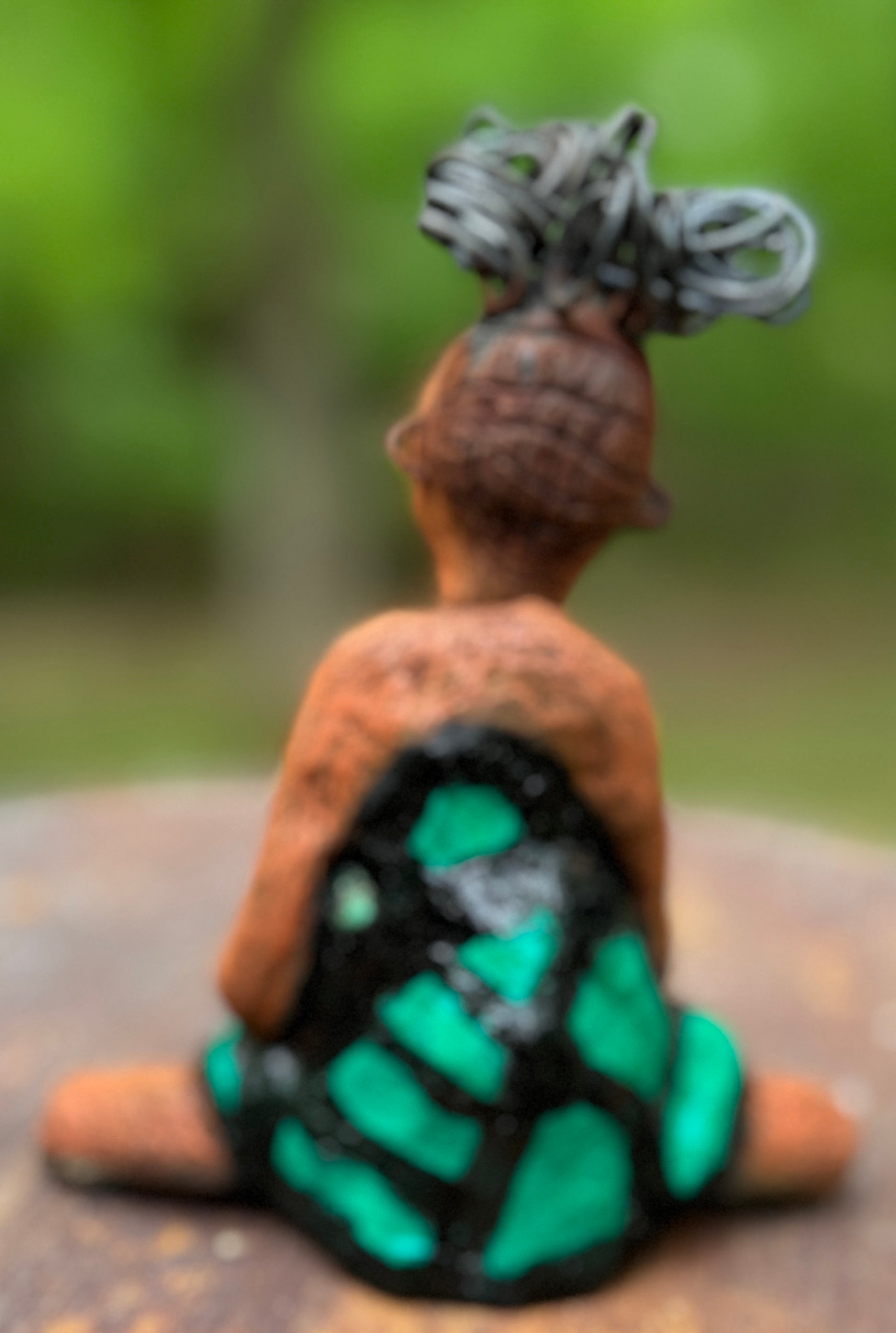 Discover Fayola, the bold figurine standing at 6" x 4” x 3” and weighing only 8.6 ozs, adorned in a striking black and green African print dress. With her hair styled in coils and her hands calmly resting in a yoga pose, Fayola emanates confidence. Join the Herdew Collection and embark on an exciting journey with our complimentary shipping and customer-friendly return policy. Don't hesitate to claim this unique treasure!