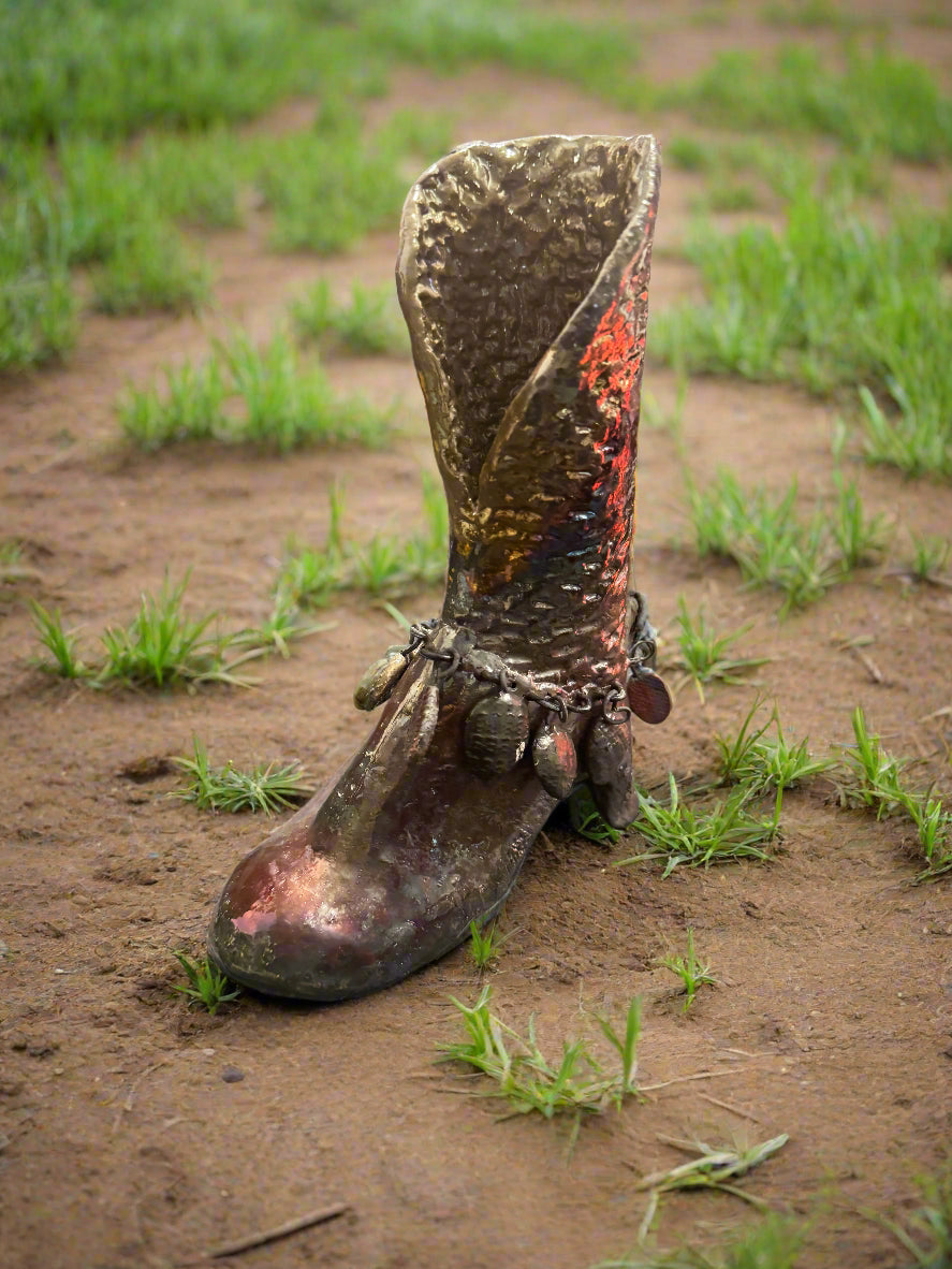 This unique Raku boot serves a dual purpose as both a functional planter and a fashionable statement piece. Combining the traditional Japanese glazing technique with a glossy finish, it measures 7.5" x 5.5" x 2" and has a weight of 1.7 pounds.