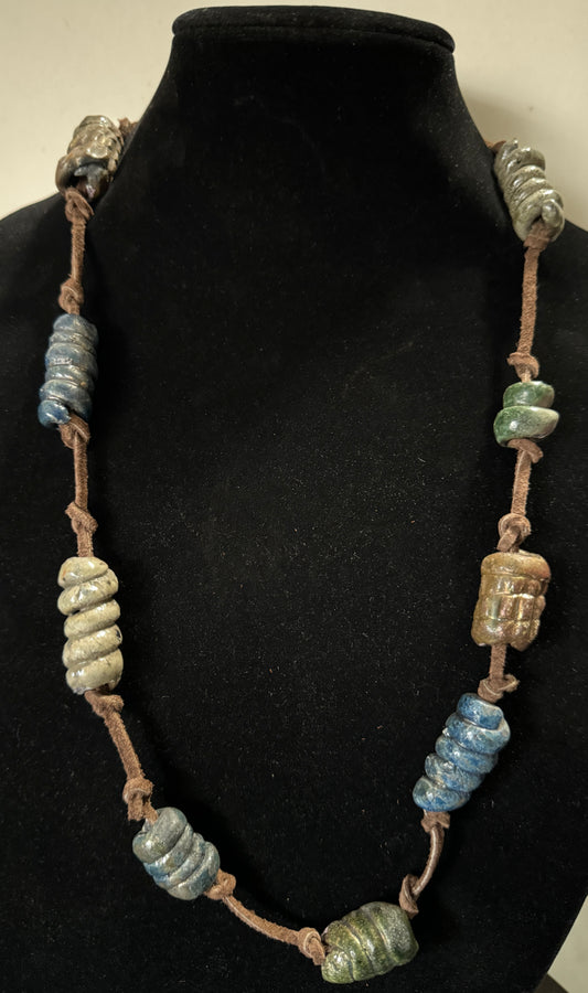 This 26” stunner features nine handmade raku beads on a brown lace cord, combining captivating design, luxurious texture, and stylish color combos to bring a bold dose of sophistication to any wardrobe. Its stand-out length makes this piece an artistic statement and a fashionable must-have!