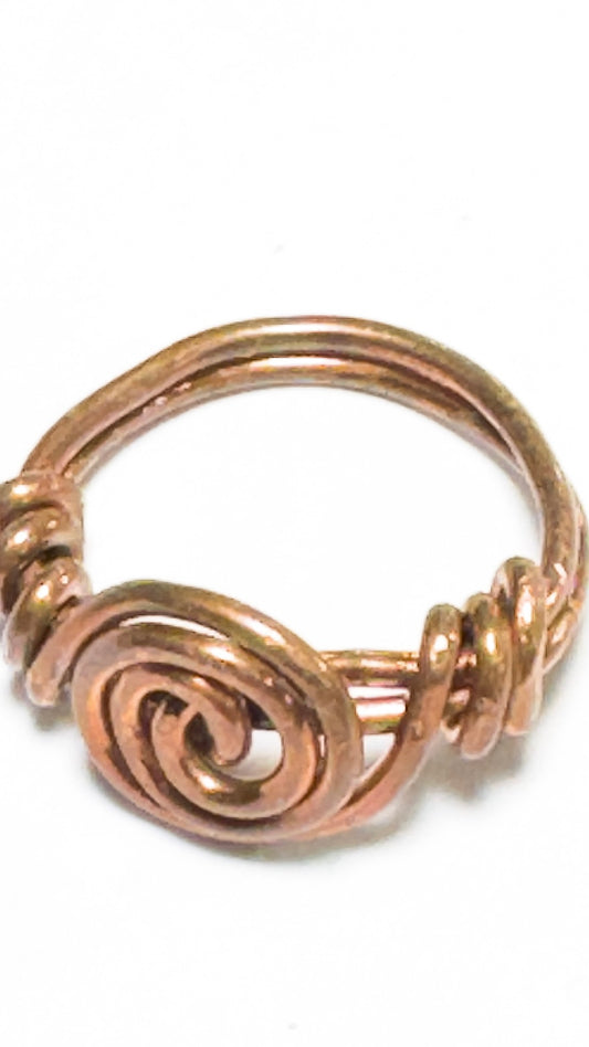 handmade spiral copper rings approx. size 7.5 This timeless design will add a touch of sophistication and elegance to your look - perfect for any occasion.