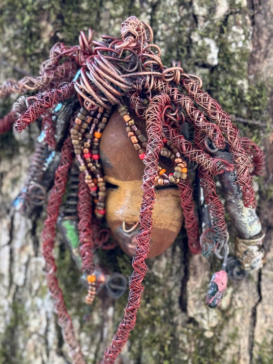 Ayanna is a wise, distinguished youth with a two-tone tribal look. He stands 7" x 10" and weighs 1 lb.  His braided hairstyle features handmade textured metallic beads plus a twist of coiled 16 gauge wire.  Questions? Send an instant message or chat with me.