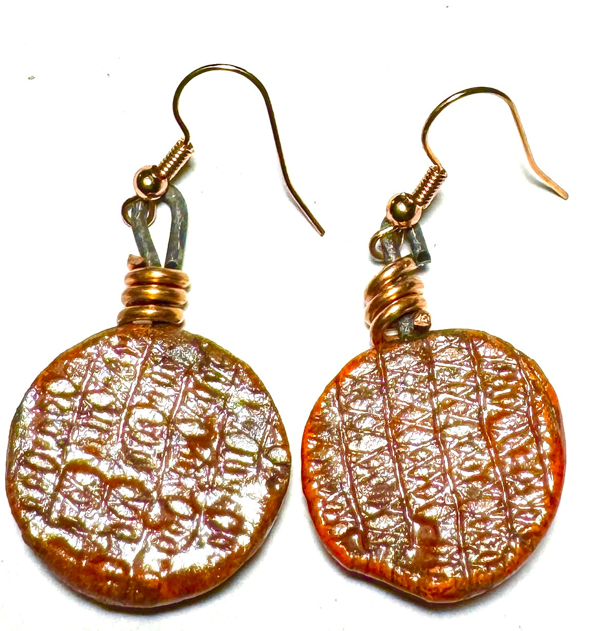 Raku Fired Earrings Shimmery Copper Luster Glazed on both sides 1/2 ounce The Raku Fired Earrings have a unique copper luster glaze that adds a special touch to any outfit. They come in a convenient 1/2 ounce pack, so you can easily take them on the go.