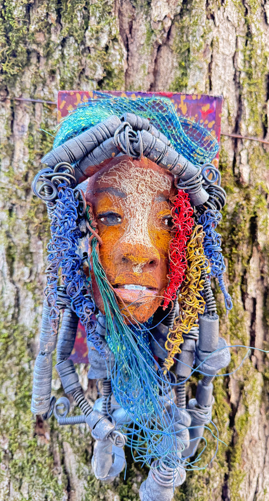 Aamadu is a member of the 2023 range of wooden-mounted tribal masks.

Meet Aamadu, the one-of-a-kind ceramic sculpture who'll make you chuckle with his contagious smile! Standing 4.5"x 8"x 1", Aamadu has a lot of fun features, like his speckled face, handmade raku-fired beads, and over 60 feet of twisted wire for hair! Best of all, it takes over two weeks of hard work to bring him to life - so snag him while you still can!
Instant Message or Chat with me.