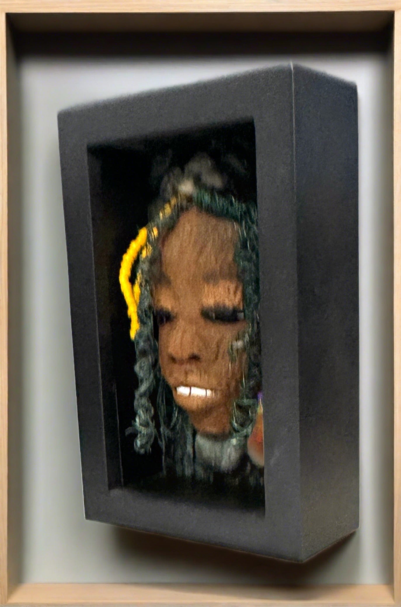 Jessie is a "4 x 6" raku mask displayed in a glass covered black shadowbox, accented with a beautiful two-tone honey brown complexion. Her intricate hair, made of 16 and 24 gauge wire, measures over 50 feet in length. With a contagious smile, Jessie adds a touch of elegance to any home decor.