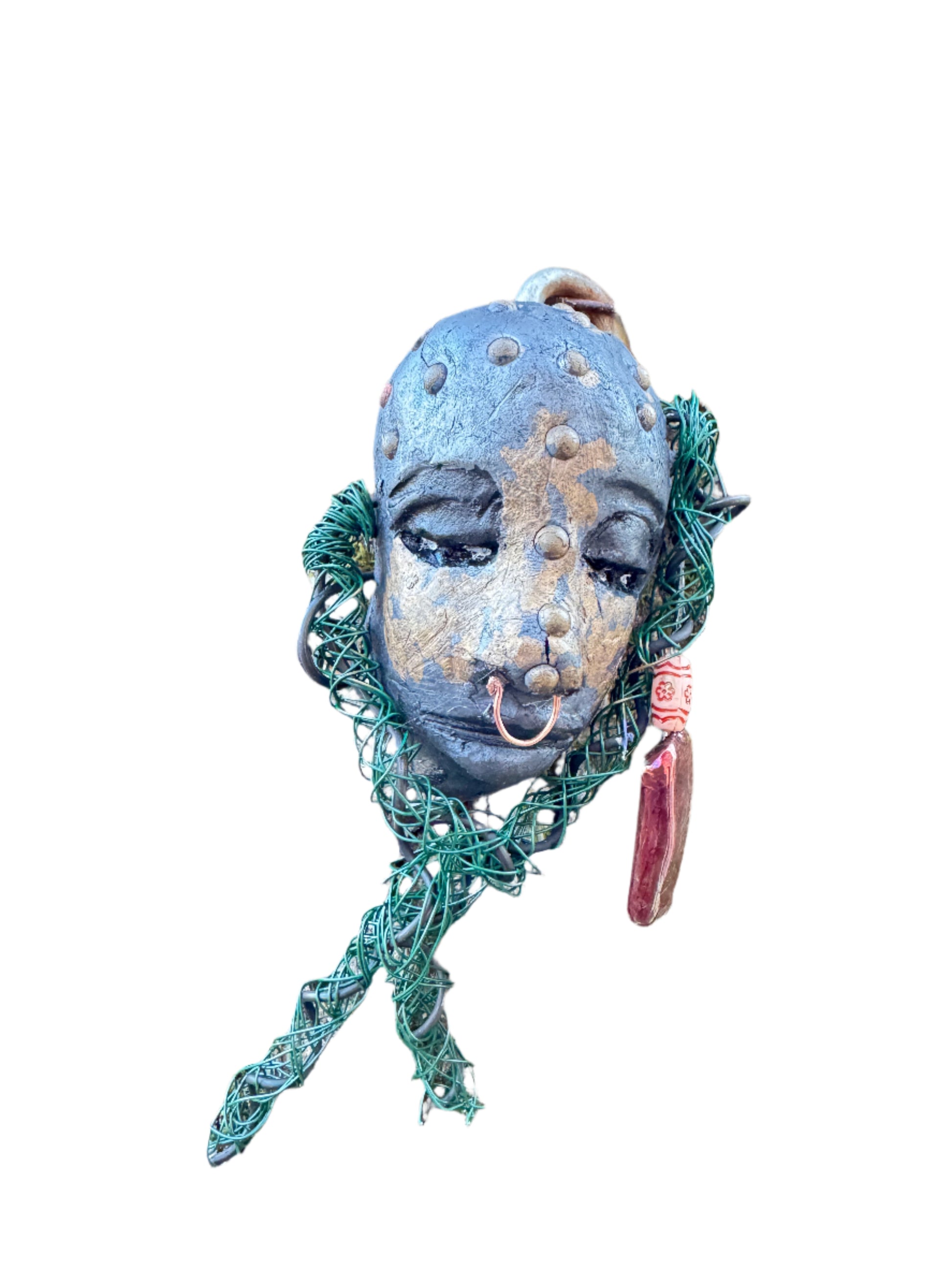 IIntroducing Addo, a unique raku fire mask made with a stunning combination of 24 and 16 gauge wire and embellished with intricate tribal beads in copper metallic. This 4 x 6" piece showcases over 15 feet of wire and can be elegantly displayed on a solid black or white surface. For a truly awe-inspiring effect, consider showcasing it against a lush, verdant forest backdrop.