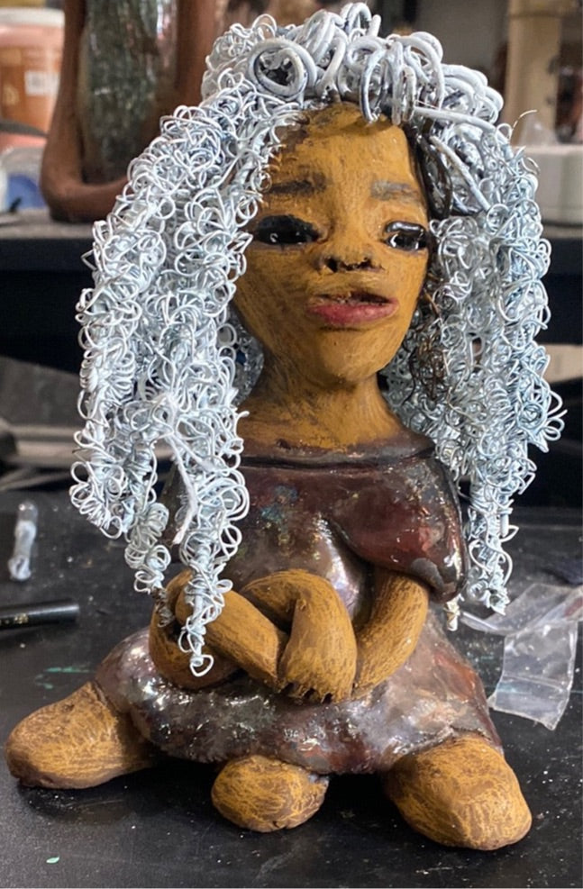 Bre' stands 7" x 5" x 4" and weighs 1.03 lbs. She has a lovely honey brown complexion with lovely reddish brown lips. Bre' wears a long white twisted hairstyle.  With eyes wide opened, Bre has hopes of finding a new home.   