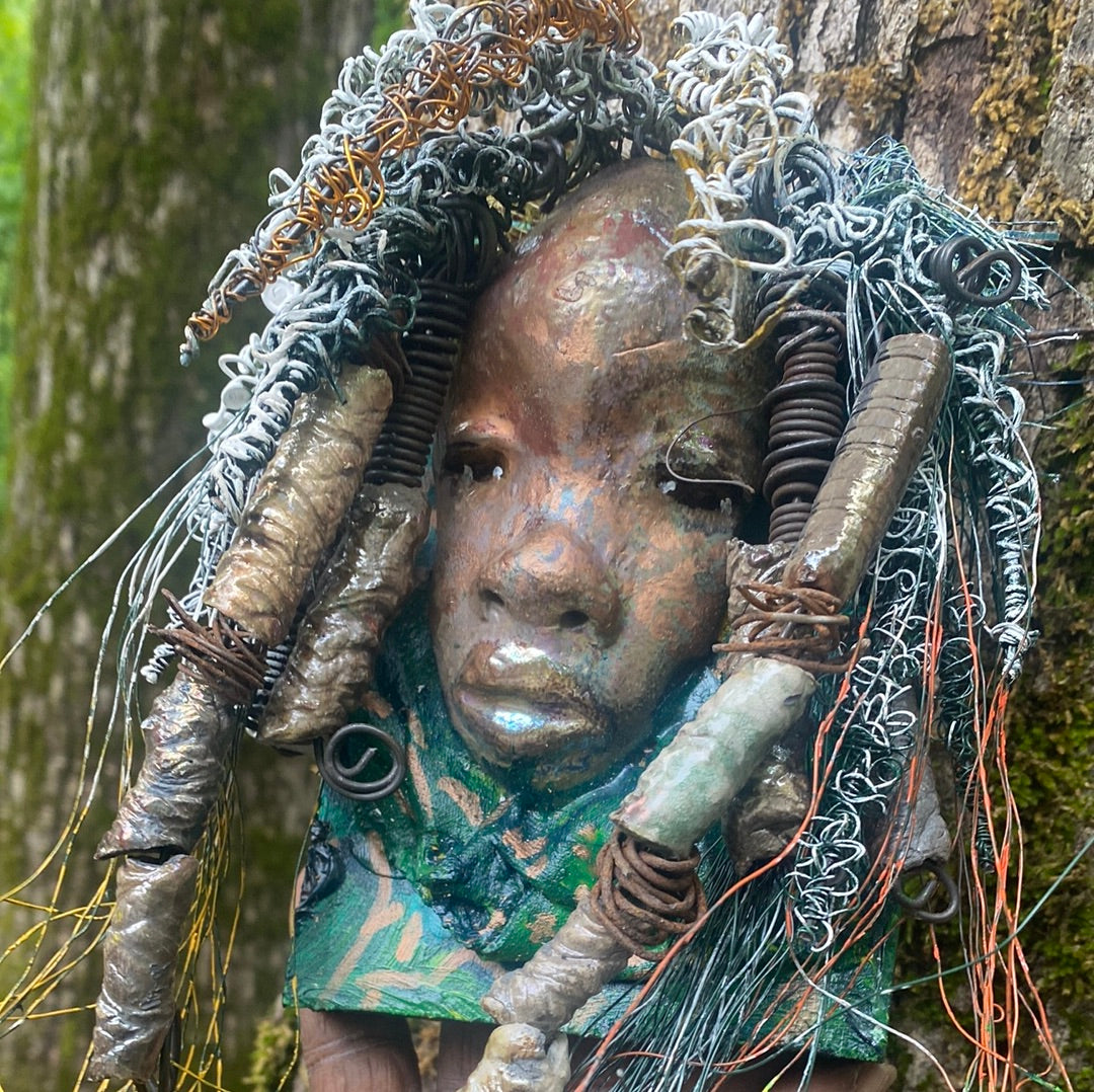 Yawa is mounted  5” x 8 x 1 and weighs 1.13 lbs.   She has a contagious smile. Yawa face is speckled. Over 20 handmade raku fired beads  Over 60 feet of 16 and 24 gauge twisted wire for hair!