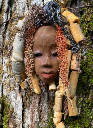 Yembe is 4”x6  ” and weighs 7ozs. She has a brown complexion. Yembe has big hair with several spiral coils handmade Raku beads. Over 30 ft of hand twisted 16 and 24 gauge wire!