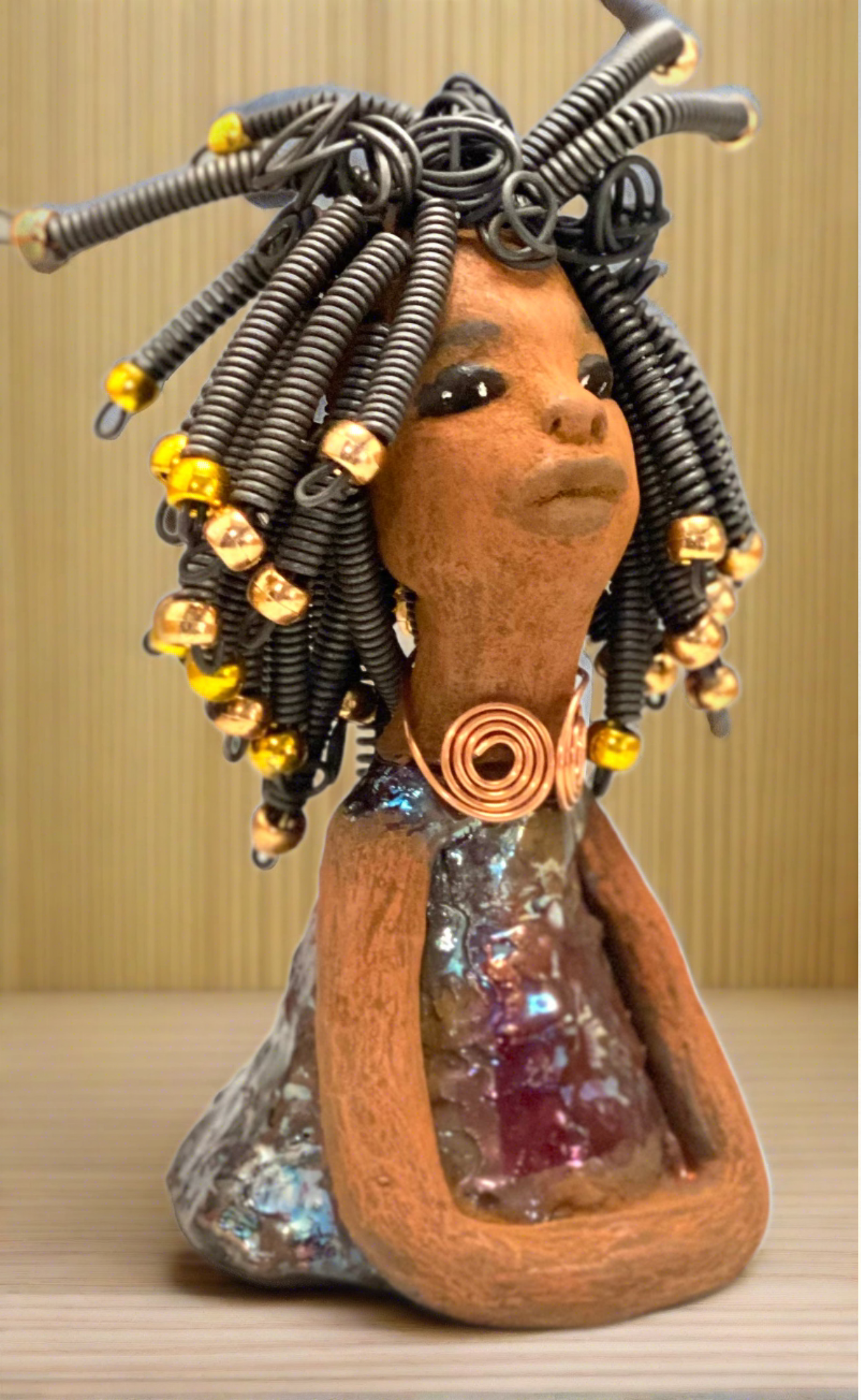 Measuring 7.5" x 4" x 4" and weighing 1.05 lbs, Alexus is dressed in a gorgeous glossy metallic gold ensemble, complete with a spiral copper necklace. Her beautiful coiled wire hair, adorned with gold beads, reaches over 15 feet long. Seated in a graceful yoga pose with her arms at her sides, Alexus is a marvelous introductory item from the Herdew Collection. Don't hesitate to reach out if you have any questions and be sure to explore our shipping and return policy.