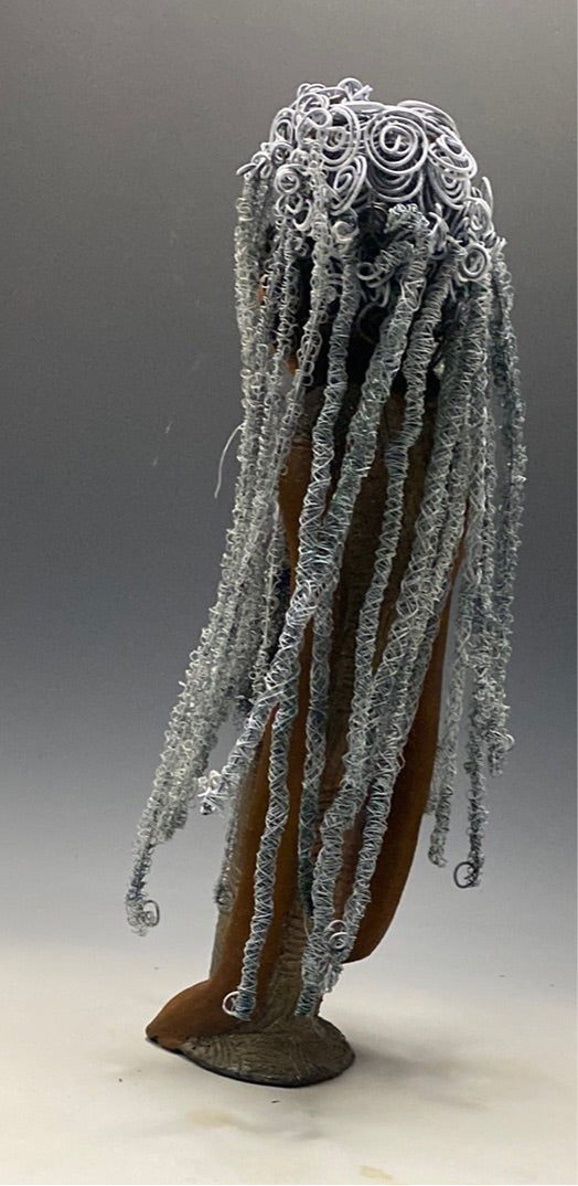 Yvette is one of my BIG girls who wants to understand what's going on!  She stands 18" x 5.5" x 4.5" and weighs 4 lbs. She wears an etched textured copper dress with a black tulle scarf.  