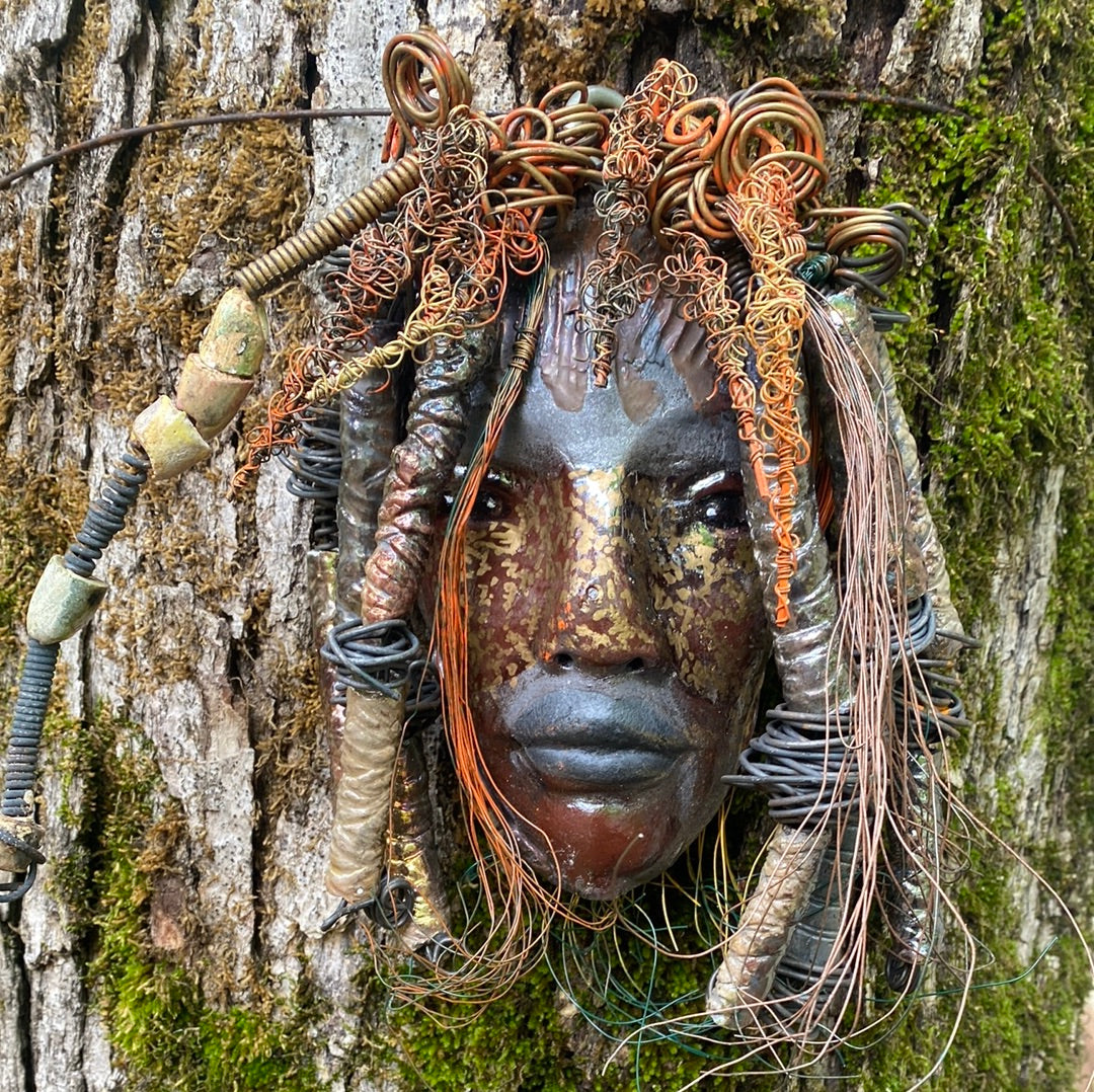 Wisal is 6"x 6”x 2" and weighs 1.6lbs. His face is formed with hand coiled wire, raku beads, and multi color  24 gauge wire. Wisal’s  face beams with a stripped brown complexion.
