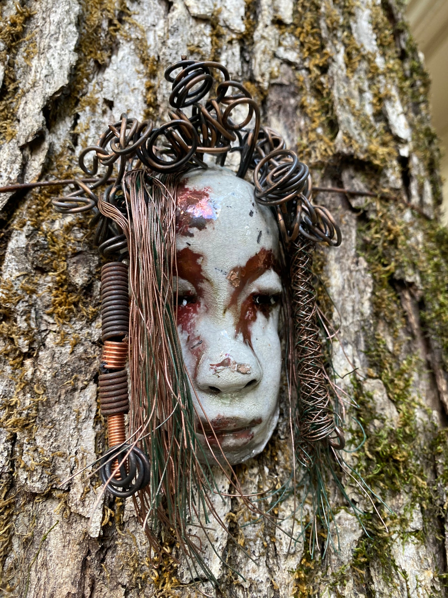 Equip your walls with the unique artwork of Weni. She is approximately 4”x5”.  Featuring over 10 ft of hair adorned, this folk art piece is sure to draw attention with its  antique white and copper crackle face and lips. Invigorate any area with a one-of-a-kind piece; perfect for starting conversations or simply for eye-catching decor! Have queries? Just ask!