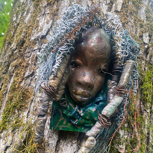 Yawa is mounted  5” x 8 x 1 and weighs 1.13 lbs.   She has a contagious smile. Yawa face is speckled. Over 20 handmade raku fired beads  Over 60 feet of 16 and 24 gauge twisted wire for hair!