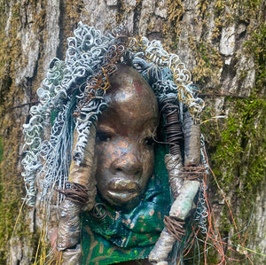 Yawa is mounted  5” x 8 x 1 and weighs 1.13 lbs.   She has a contagious smile. Yawa face is speckled. Over 20 handmade raku fired beads  Over 60 feet of 16 and 24 gauge twisted wire for hair!