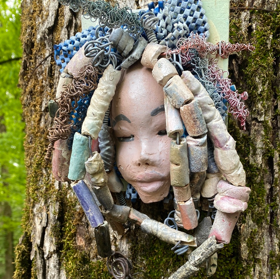 Zaire is mounted on a  5"x 6" painted wood canvas. I spent about 4 hours or more just  fixing her hair and attaching beads!  Zaire has over 100 feet of 16 and 24 gauge wire for hair. Zaire has a white crackle face with dark gray lips. She weighs 2.10 lbs  and is ready to be hung!