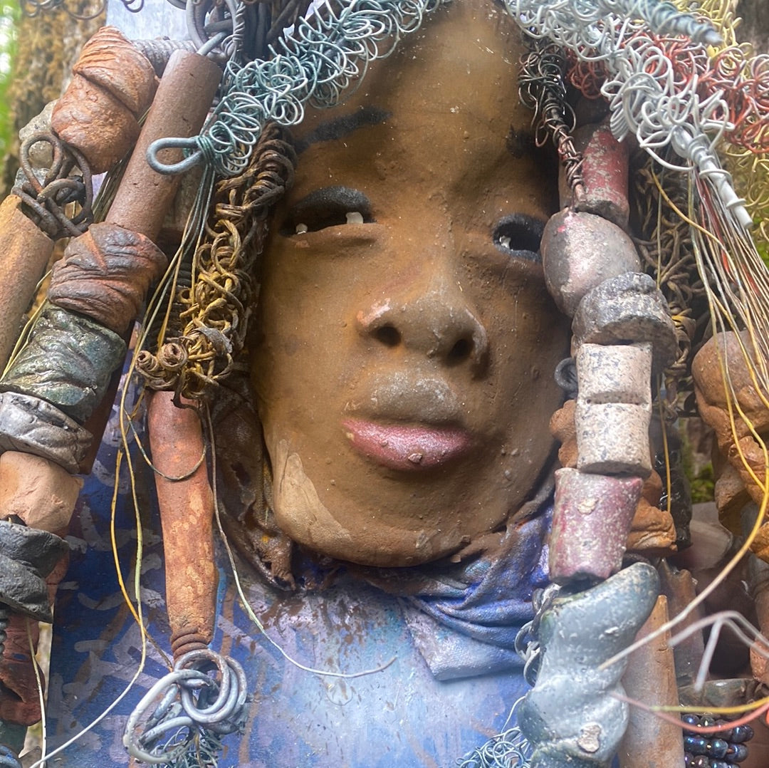 Valarie is mounted  5” x 8 x 1 and weighs 1.13 lbs.   She has a contagious smile. Valarie face has a lovely honey brown complexion. She has over 20 handmade raku fired beads  Over 60 feet of 16 and 24 gauge twisted wire for hair!