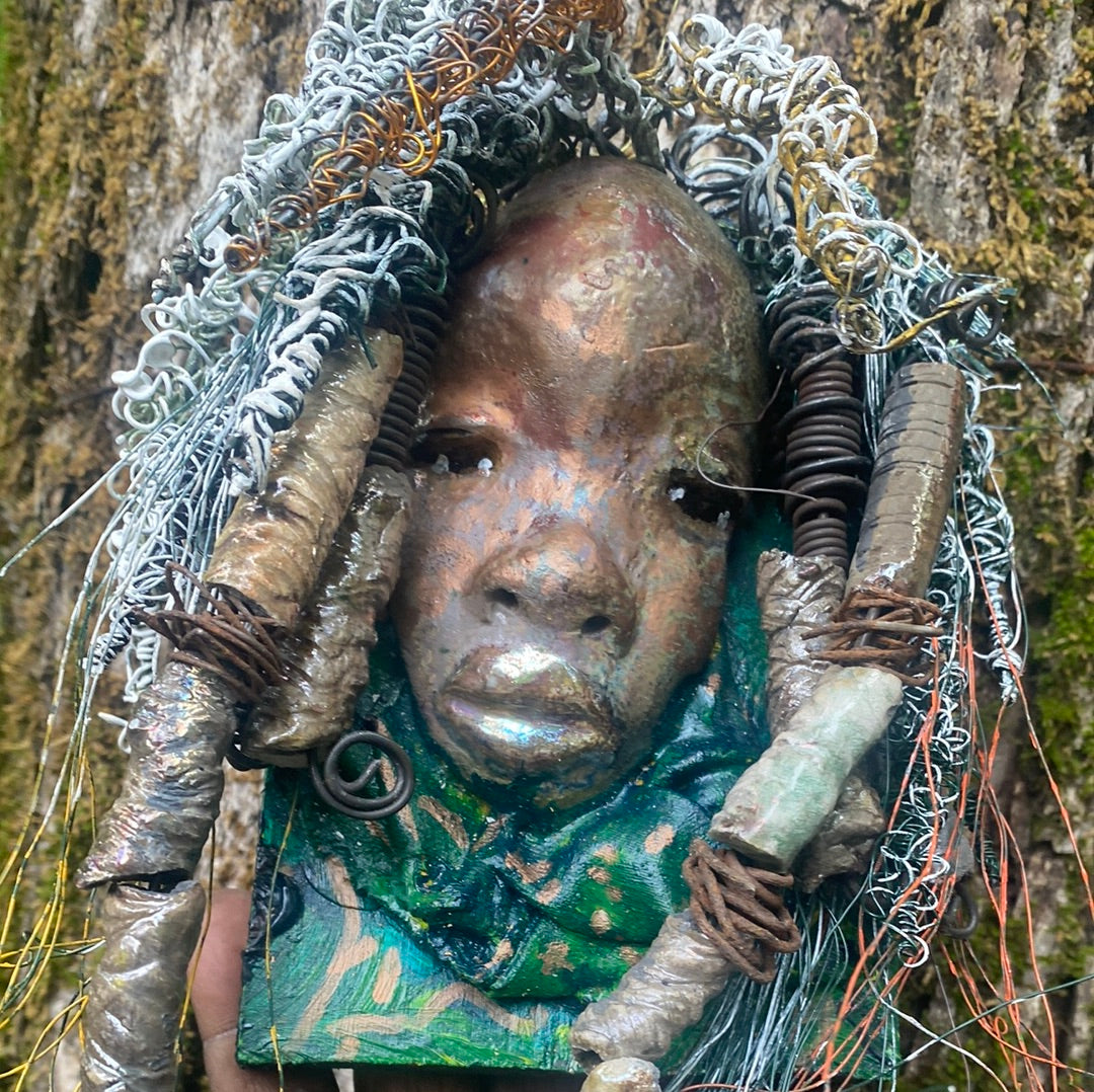 Yawa is mounted  5” x 8 x 1 and weighs 1.13 lbs.   She has a contagious smile. Yawa face is speckled. Over 20 handmade raku fired beads  Over 60 feet of 16 and 24 gauge twisted wire for hair!