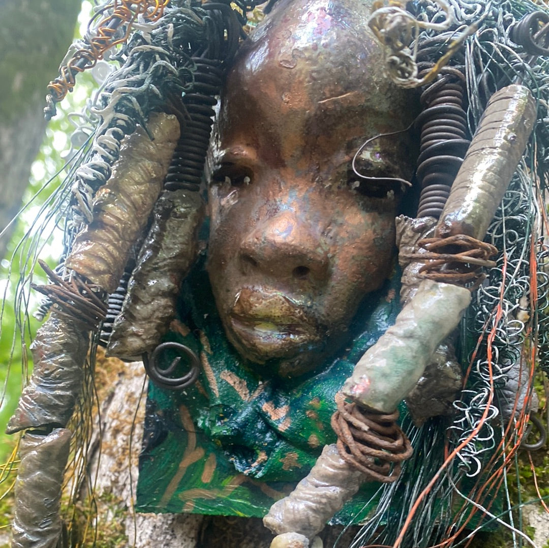 Yawa is mounted  5” x 8 x 1 and weighs 1.13 lbs.   She has a contagious smile. Yawa face is speckled. Over 20 handmade raku fired beads  Over 60 feet of 16 and 24 gauge twisted wire for hair!