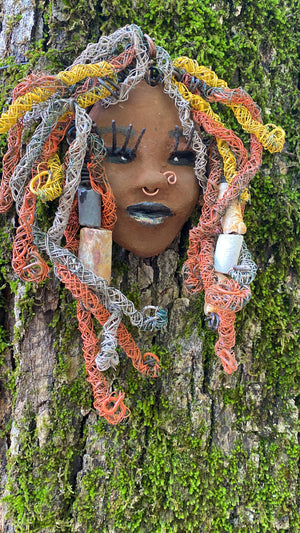 Introducing Nala, the 5" x 7" whimsical mask with a cocoa copper complexion. Its handmade textured dreadlocks and coiled 16 gauge wire provide a unique look that's not found in typical masks. Nala is the perfect conversationalist for your wild inquiries, so don't hesitate - give her a shout! My art journey began after I visited the Smithsonian Museum of African Art, and I was inspired to create Nala.