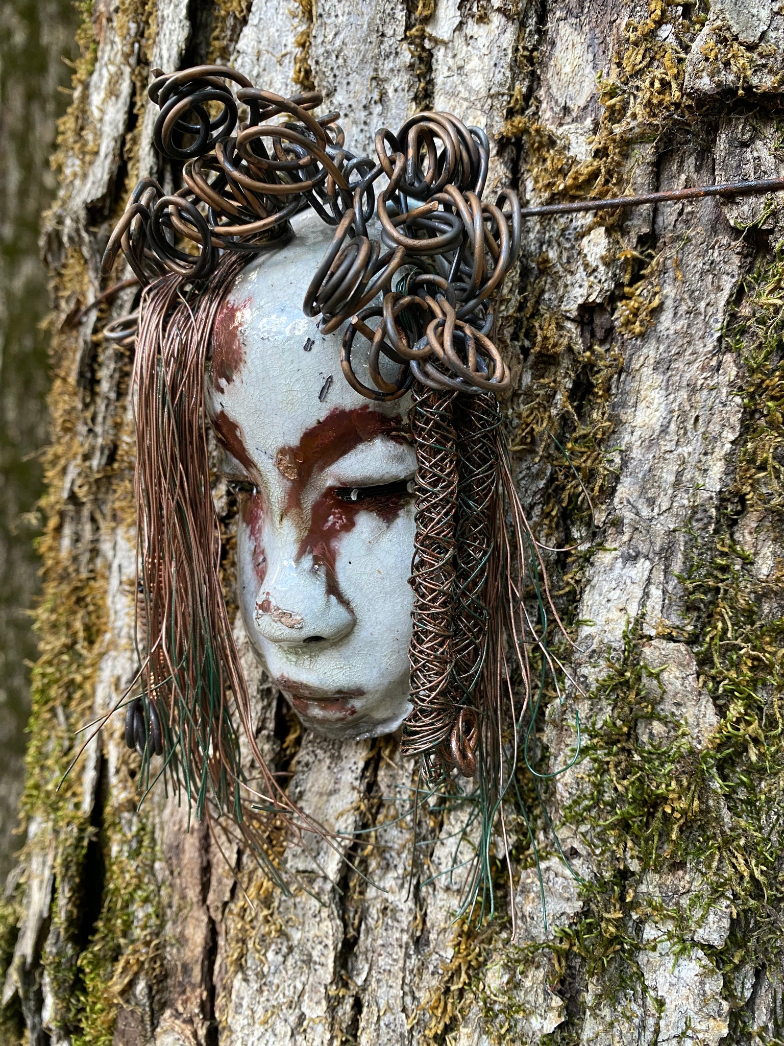 Equip your walls with the unique artwork of Weni. She is approximately 4”x5”.  Featuring over 10 ft of hair adorned, this folk art piece is sure to draw attention with its  antique white and copper crackle face and lips. Invigorate any area with a one-of-a-kind piece; perfect for starting conversations or simply for eye-catching decor! Have queries? Just ask!
