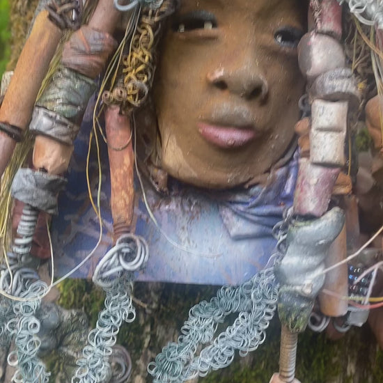 Valarie is mounted  5” x 8 x 1 and weighs 1.13 lbs.   She has a contagious smile. Valarie face has a lovely honey brown complexion. She has over 20 handmade raku fired beads  Over 60 feet of 16 and 24 gauge twisted wire for hair!