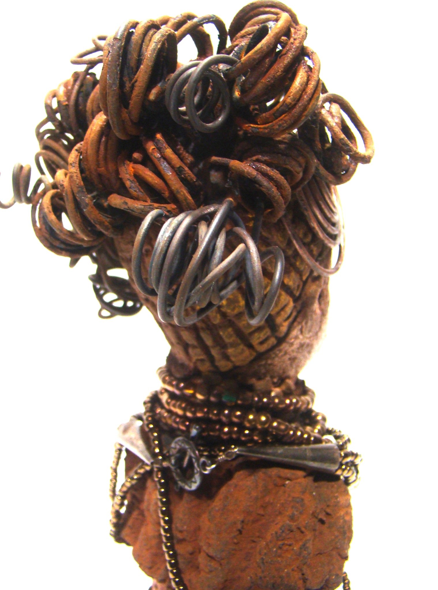 Cardi stands 11" x 5.5" x 3" and weighs 1.14 lbs. She has an awesome two tone honey beige complexion. Cardi wears a dark metallic copper dress with a chocolate ruffle scarf.  She wears a multitude of amber colored hand strung beads. I do believe Cardi would like it if you gave her a space in your home!