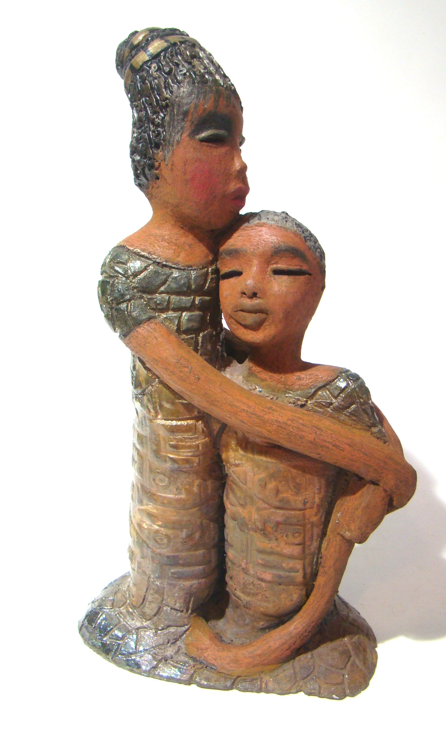 Girl Talk with my Mom stands 13' x 7" x 4" and weighs 14.lbs. They were raku fired etched metallic copper dresses. Their hair is made of clay and raised into an etched bun. They have lovely honey brown complexions and long loving arms. Girl Talk with my Mom would remind one of those special moments in tim