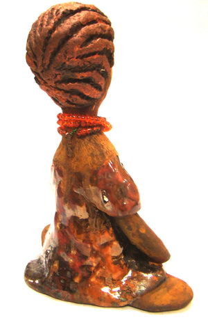Meet Devonte! ﻿Devonte stands 8" x 6" x  4" and weighs 1.06 lbs. Devonte has a awesome honey brown complexion. She has braided clay hair. Devonte has long loving arms. She wears a metallic copper dress with red orange beads. Give Devonte a special place in your home!