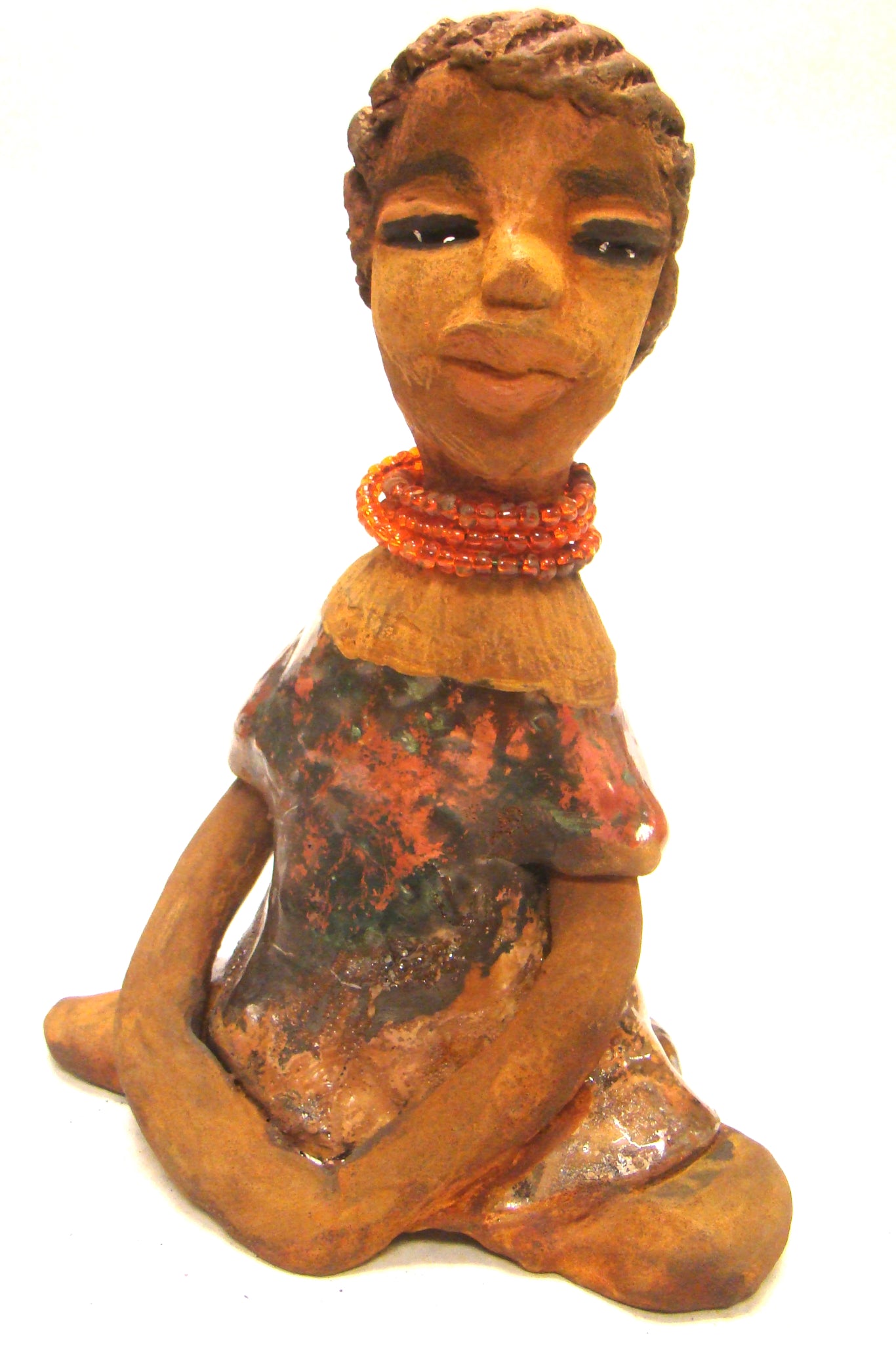 Meet Devonte! ﻿Devonte stands 8" x 6" x  4" and weighs 1.06 lbs. Devonte has a awesome honey brown complexion. She has braided clay hair. Devonte has long loving arms. She wears a metallic copper dress with red orange beads. Give Devonte a special place in your home!